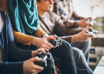 Group of friends playing digital games at home.